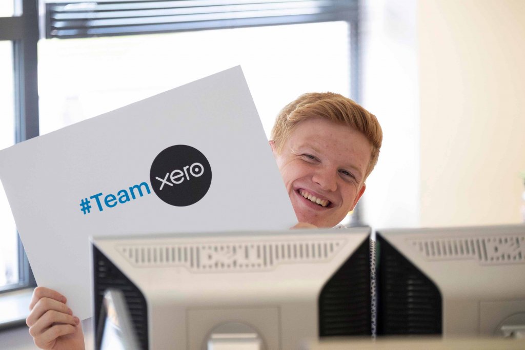 Whyfield team member holding Team Xero sign